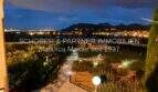 Illuminated garden at night with panoramic view of Son Servera and mountain silhouette, Mallorca property