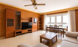 Helles Wohnzimmer mit Holzvertäfelung, TV-Einheit, Esstisch und Meerblick in Strandnähe Palma