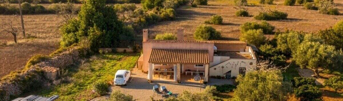 Aerial view of an idyllic finca near Felanitx with terrace, carport, olive trees and wide views over the landscape.