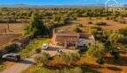 Aerial view of an idyllic finca near Felanitx with terrace, carport, olive trees and wide views over the landscape.