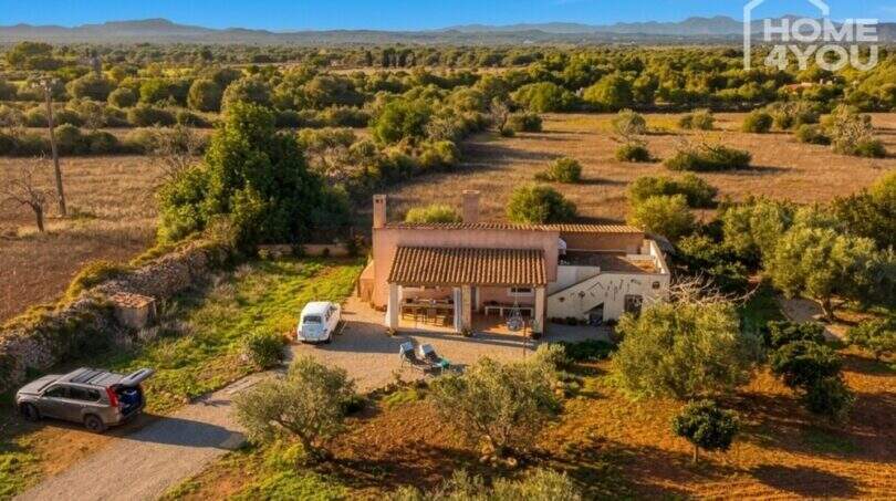 Aerial view of an idyllic finca near Felanitx with terrace, carport, olive trees and wide views over the landscape.