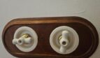 Vintage Lichtschalter aus Porzellan auf Holzplatte mit Messingdetails im modernisierten Stadthaus Petra