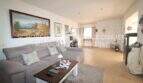 Bright living room with gray sofa, coffee table, fireplace and Mediterranean painting in Son Servera