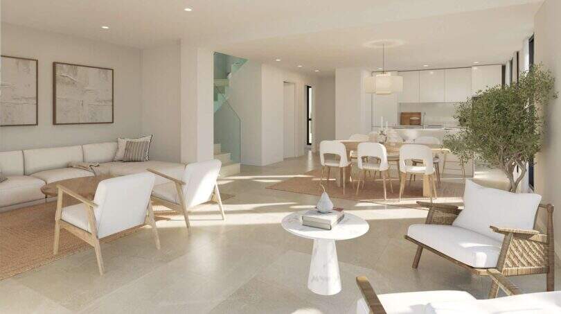 Heller Wohnbereich im Neubau-Chalet Palma mit offener Küche, modernen Möbeln und Treppe zum Obergeschoss.
