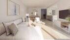 Helles Wohnzimmer mit offenem Grundriss, moderner Küche und natürlichen Materialien im Neubau-Chalet Palma