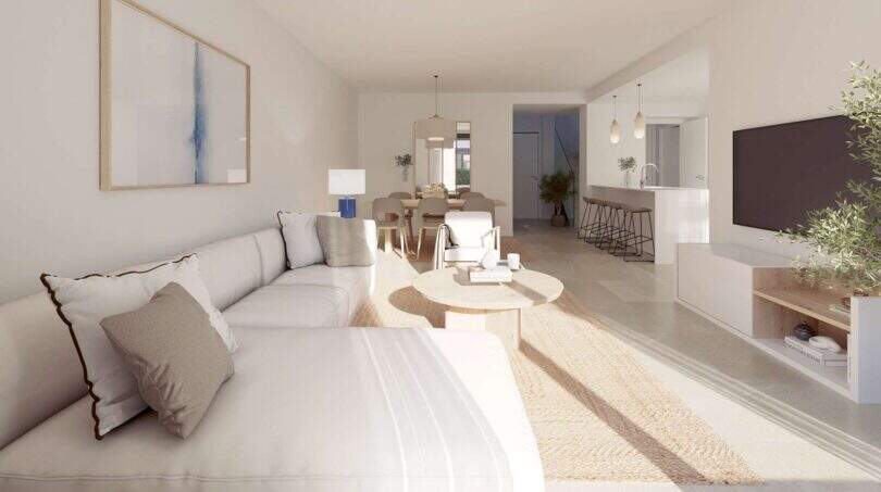 Helles Wohnzimmer mit offenem Grundriss, moderner Küche und natürlichen Materialien im Neubau-Chalet Palma