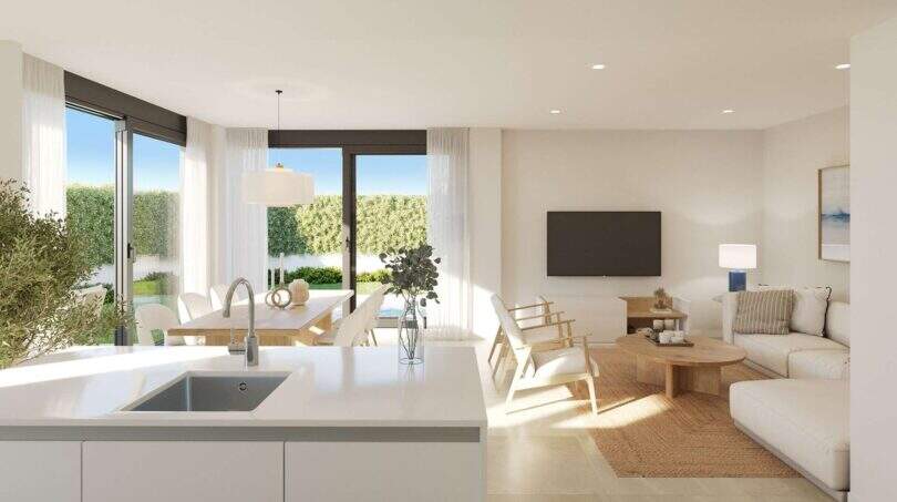 Heller Wohn-Essbereich mit offener Küche, modernem Design und Zugang zum Garten im Neubau-Chalet Palma