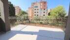 Amplia terraza con barandilla de metal, vistas al jardín y casas multifamiliares en Cala Millor, complejo de apartamentos de nueva construcción