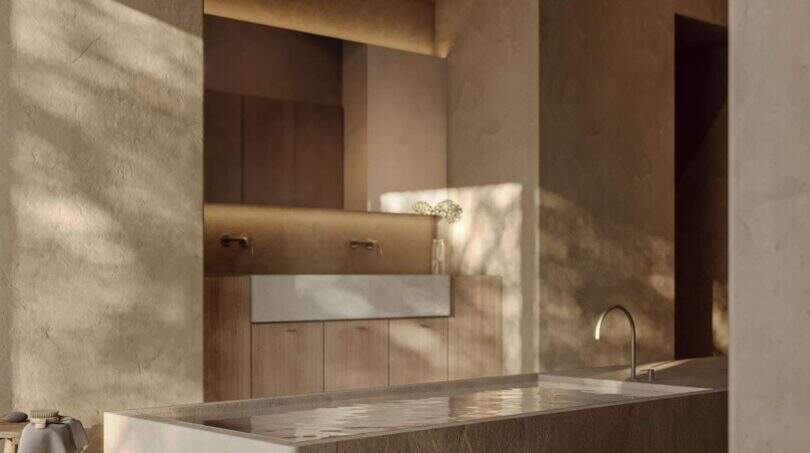 Luxus-Badezimmer der Designer-Villa Santanyí mit freistehendem Steinbad und warmen Erdtönen