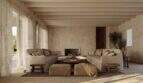 Helles Wohnzimmer der Designer-Villa Santanyí mit Natursteinwänden, Holzbalken und eleganter Sitzlandschaft in Erdtönen.