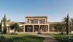 Außenansicht der Designer-Villa in Santanyí mit Natursteinfront, Terrassenbereich und mediterranem Garten.