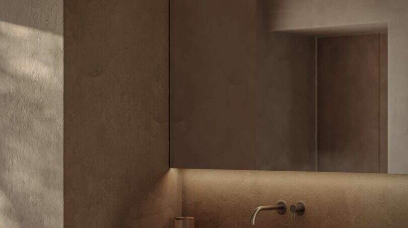Minimalistisches Badezimmer der Designer-Villa Santanyí mit Naturstein-Waschtisch, Holzunterschrank und indirekter Beleuchtung.