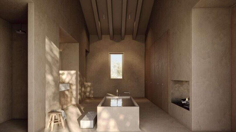 Rustikales Badezimmer der Designer-Villa Santanyí mit Naturstein, Freistehbadewanne und Kamin