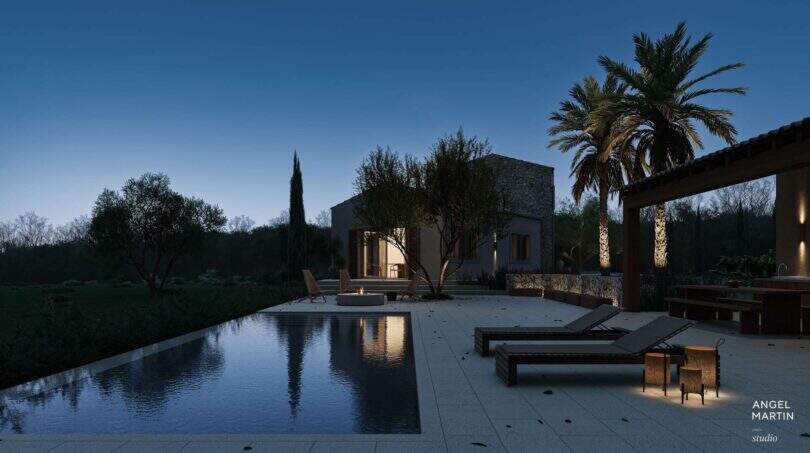 Abendstimmung: Infinity-Pool mit Liegestühlen und beleuchteter Steinfassade der Designer-Villa in Santanyí