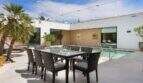 Modern terrace with dining table, chairs and pool at design house in S'Alqueria Blanca