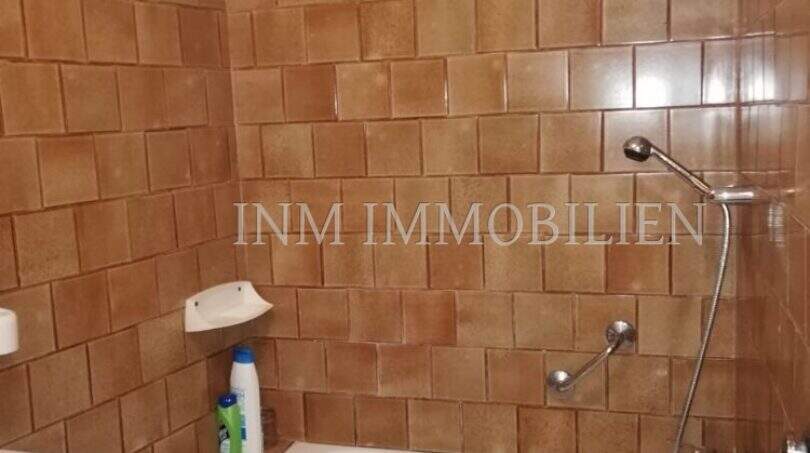 Badezimmer mit Badewanne und braunen Fliesen im Dorfhaus Felanitx