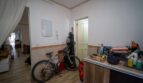 Entrada con zócalo de azulejos, bicicleta y paso al salón en la casa multifamiliar alquilada en Felanitx.