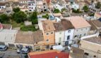 Fotografía aérea de una casa multifamiliar en Felanitx con arquitectura típicamente mallorquina y techos de tejas.