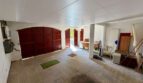 Spacious garage of the retro villa in Porto Cristo with three wooden doors and flat roof