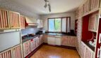 Retro kitchen with red and white striped cabinets, marble counter and terracotta floor in Villa Porto Cristo