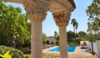 Classic columned arbor with view of the pool of the retro villa in Porto Cristo