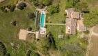 Aerial view of an exclusive finca in Felanitx with large pool, garden facilities and outbuildings.