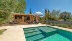 Felanitx finca: Pool with jacuzzi, natural stone terrace, lounge area and lavender garden under blue sky