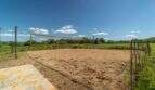 Sand volleyball court with yellow net on exclusive finca in Felanitx, surrounded by green landscape.