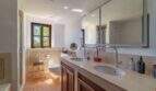 Elegant double sink bathroom of the Felanitx finca with marble vanity and mosaic tiles