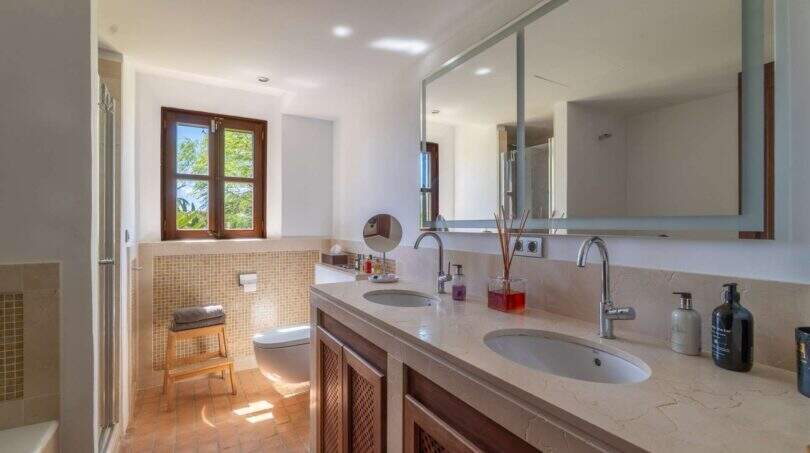 Elegant double sink bathroom of the Felanitx finca with marble vanity and mosaic tiles