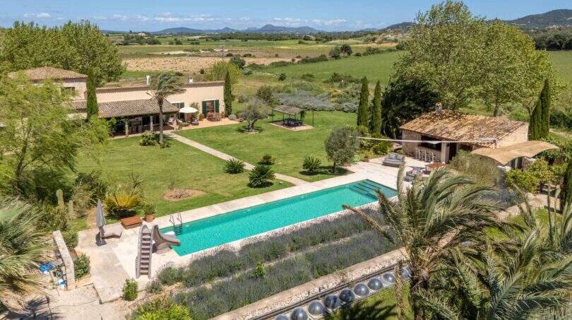 Aerial view of the Felanitx finca with large pool, lavender beds, palm trees and view of the vineyards