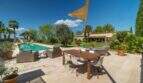 Sunny terrace with pool, dining table and lounge of the exclusive finca in Felanitx