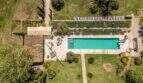 Aerial view: Rectangular pool with terrace, lounge furniture and well-maintained garden of the Felanitx finca