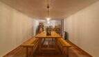 Wine cellar of the Felanitx finca with wooden table, benches, wine racks and atmospheric lighting