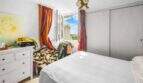 Schlafzimmer der Wohnung in Porto Colom mit Doppelbett, Kleiderschrank und Fenster mit Meerblick