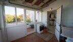 Verglaster Übergangsbereich mit Wäschetrockner, Terrassenzugang und Blick auf Grünflächen in Porto Colom