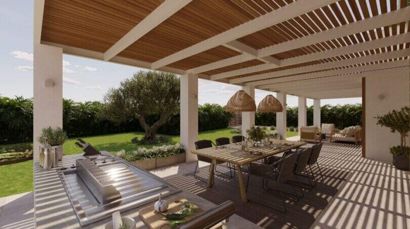 Überdachte Terrasse mit Holzpergola, Außenküche, Esstisch und Gartenblick in Designvilla Cala Murada