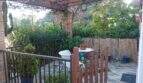 Terrace of the chalet in Cala Murada with seating group, pergola, lush plants and bamboo wall privacy screen.