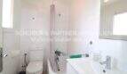 Cuarto de baño luminoso con bañera, ducha, WC y lavabo en apartamento modernizado en Cala Ratjada