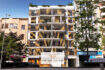 Modern exterior facade of the new building Cor 39 in Palma with wooden slats, balconies and green roof in the city center.