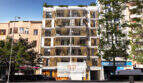 Moderne Außenfassade des Neubaus Cor 39 in Palma mit Holzlamellen, Balkonen und Dachbegrünung im Stadtzentrum.