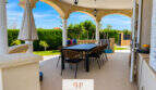 Überdachte Terrasse mit Bogensäulen, Esstisch und Gartenblick der Villa in Sa Torre, Llucmajor