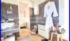 Elegant bathroom with dark tiles, sink, bathrobe and vanity in Villa Son Servera