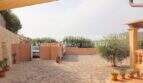 Paved courtyard with olive tree, view of garage and panoramic landscape in Son Servera