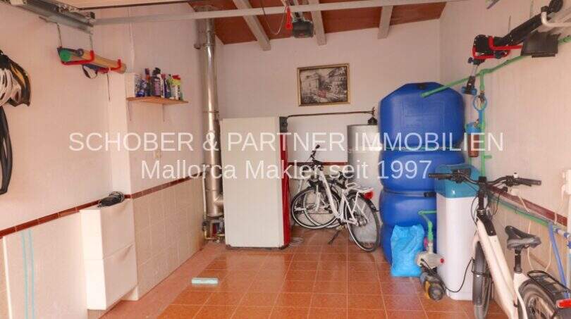 Garage with bicycles, heating equipment, water tanks and storage space in villa with sea view, Son Servera