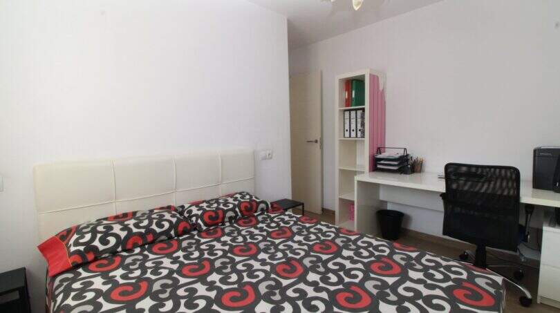 Helles Schlafzimmer mit Doppelbett, Schreibtisch und Regal im Penthouse-Maisonette in Palma de Mallorca