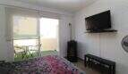 Helles Schlafzimmer mit Doppelbett, Wandmontiertem TV und Zugang zur Terrasse mit Sitzbereich im Penthouse Palma