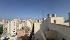 Panoramablick vom Dachterrasse der Penthouse-Maisonette über die Stadtdächer von Palma de Mallorca bei blauem Himmel.