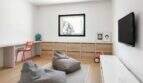 Kinderzimmer mit Holzkommode, Beanbags, Schreibtisch und Wandtv in modernem Anwesen in Marratxí.