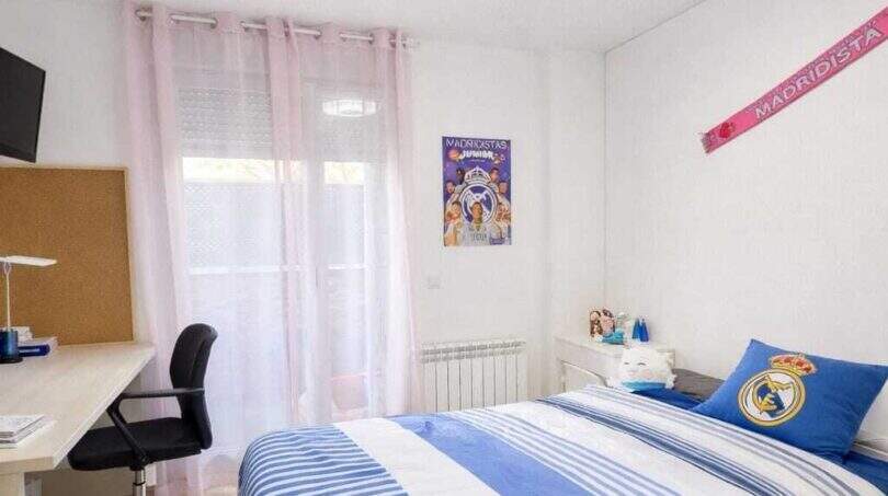 Bright children's room with Real Madrid bedding, desk and balcony access in ground floor apartment Palma.